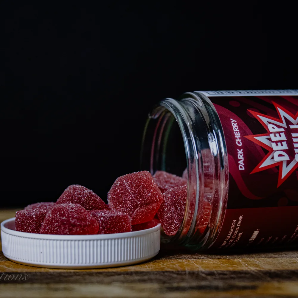 BAMM Deep Chill glass jar with dark cherry gummies on a dark studio backdrop.