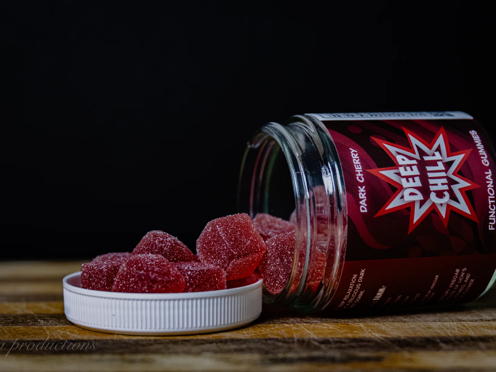 BAMM Deep Chill glass jar with dark cherry gummies on a dark studio backdrop.