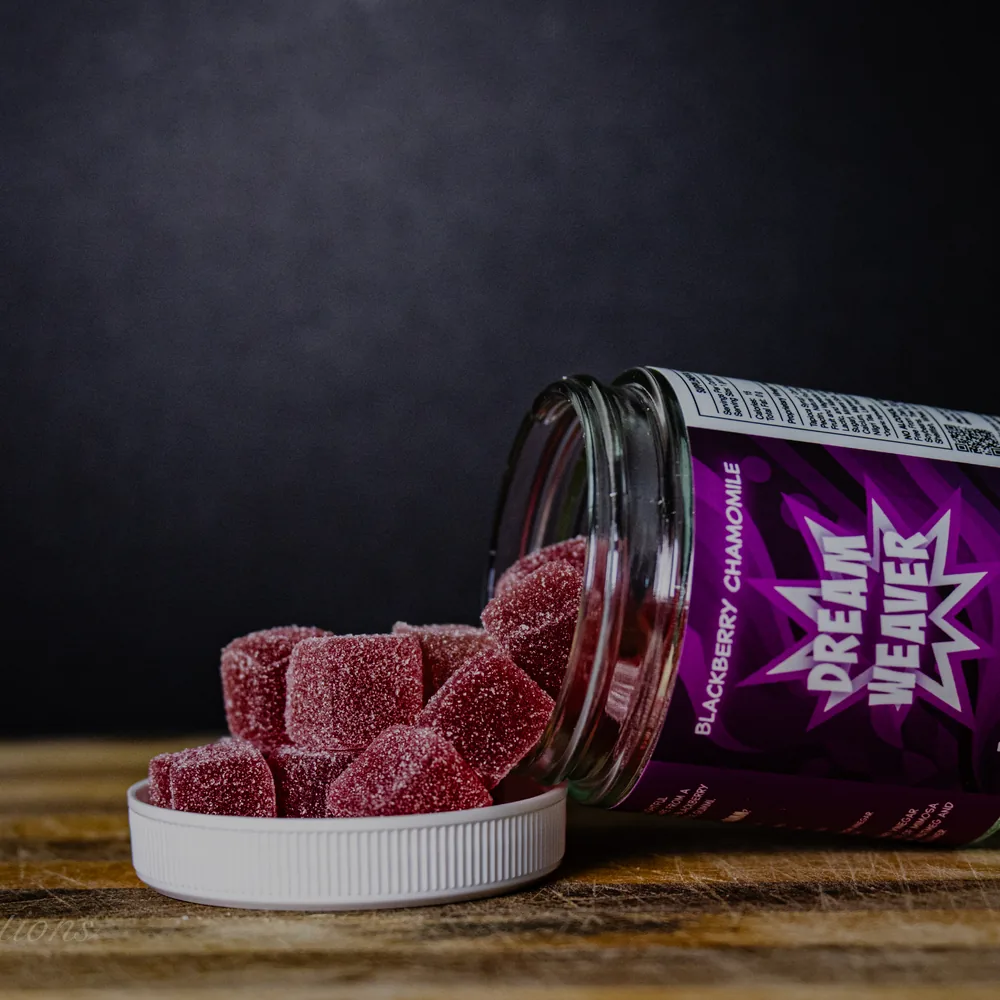 BAMM Dream Weaver glass jar with blackberry chamomile gummies on a dark studio backdrop.