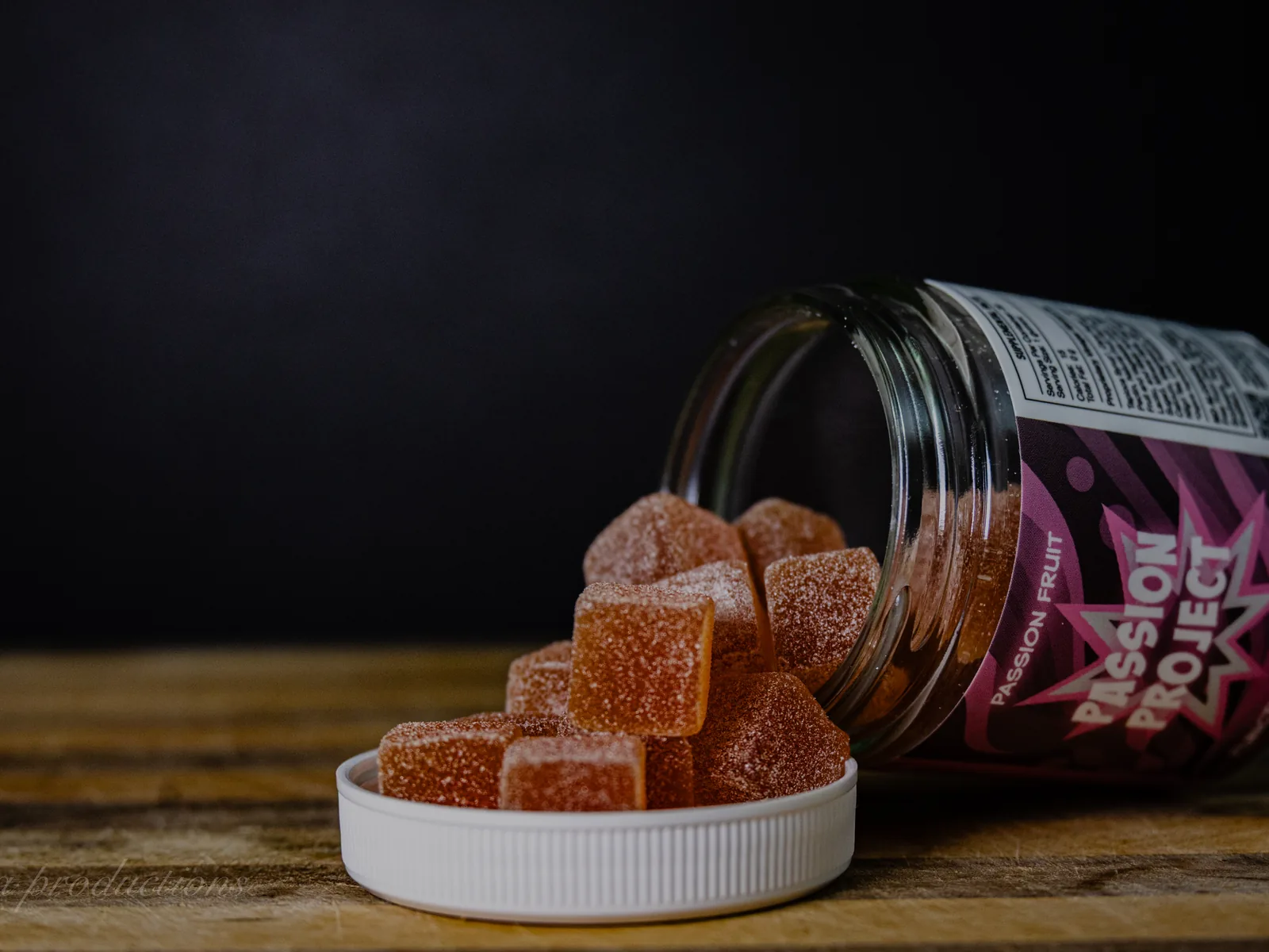 BAMM Passion Project glass jar with passion fruit gummies on a dark studio backdrop.